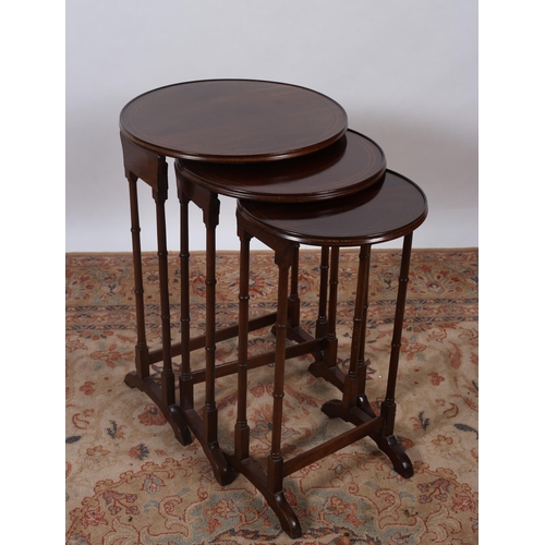 430 - A NEST OF THREE EDWARDIAN MAHOGANY AND SATINWOOD INLAID TABLES each of circular outline the shaped t... 