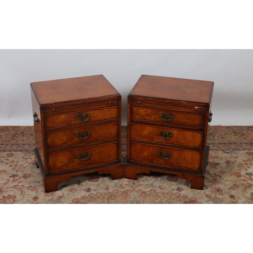 432 - A PAIR OF WALNUT CHESTS each of rectangular outline the shaped top above a brush and slide and three... 