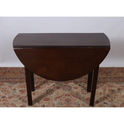 454 - A GEORGIAN MAHOGANY DROP LEAF TABLE the oval hinged top raised on square moulded legs 
74cm (h) x 27... 