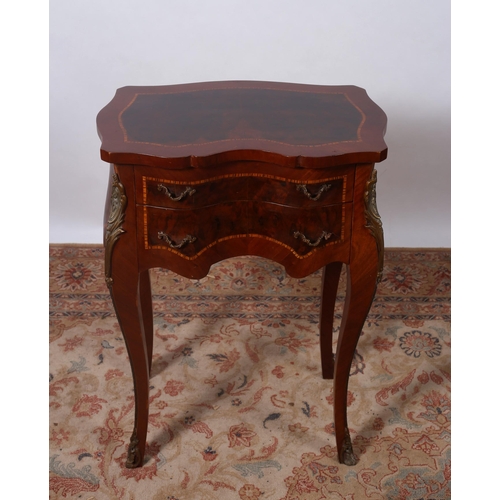 455 - A CONTINENTAL KINGWOOD GILT BRASS MOUNTED AND INLAID SIDE TABLE of serpentine outline the shaped top... 