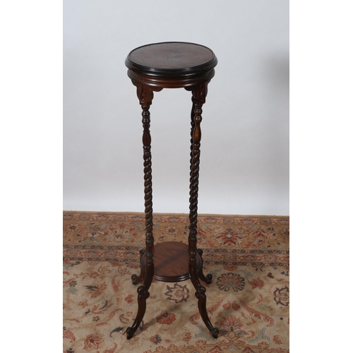 459 - A MAHOGANY JARDINIERE STAND of circular form the shaped top raised on spiral twist supports with spl... 