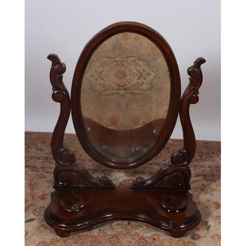 473 - A VICTORIAN MAHOGANY CRUTCH FRAME MIRROR the oval plate within a moulded frame raised on carved scro... 