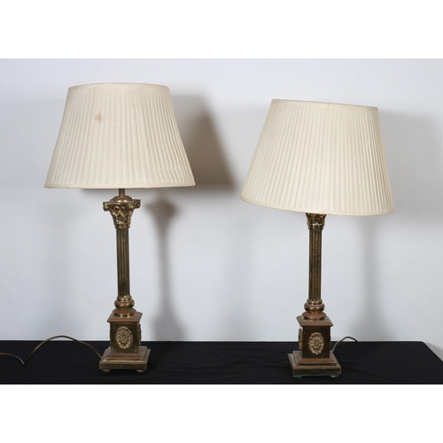 476 - A PAIR OF BRASS CORINTHIAN COLUMN TABLE LAMPS each with a reeded column above a square platform on s... 