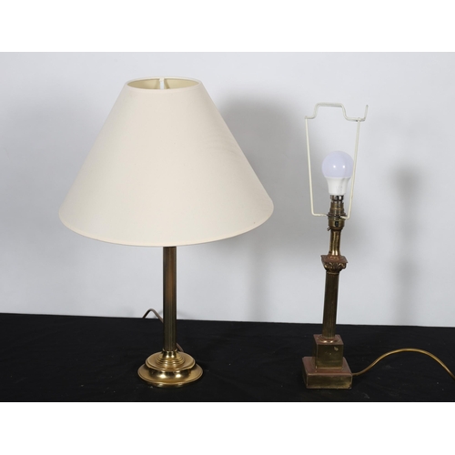 480 - A BRASS TABLE LAMP the reeded column above a circular spreading foot with shade
56cm (h)
together wi... 