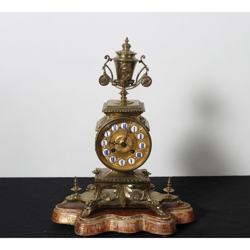 481 - A 19TH CENTURY GILT BRASS MANTEL CLOCK  the cylinder drum with enamel Roman numerals with urn cresti... 