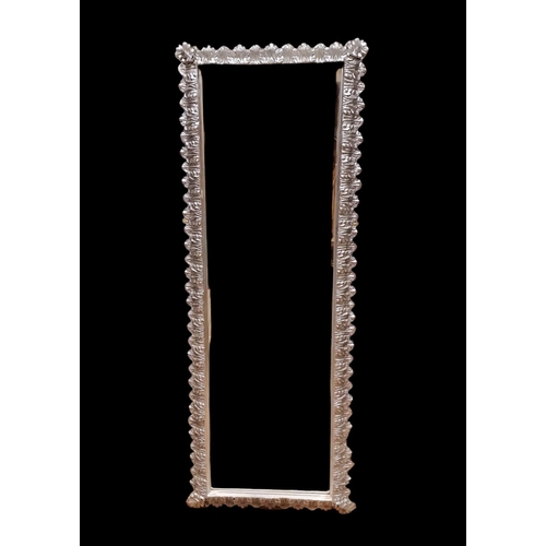 490 - A CONTINENTAL SILVERED FRAME MIRROR the rectangular bevelled glass plate within a foliate moulded fr... 