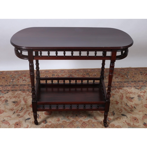 503 - A VINTAGE MAHOGANY TWO TIER TABLE of oval outline the shaped top with baluster splats on ring turned... 