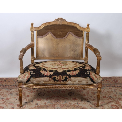 504 - A 19TH CENTURY FRENCH CARVED GILTWOOD AND NEEDLEWORK UPHOLSTERED SETTEE the shaped top rail with flo... 