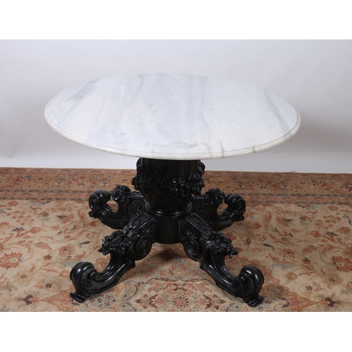 505 - A 19TH CENTURY CARVED MAHOGANY AND MARBLE TOP TABLE the circular white veined marble top above a fol... 