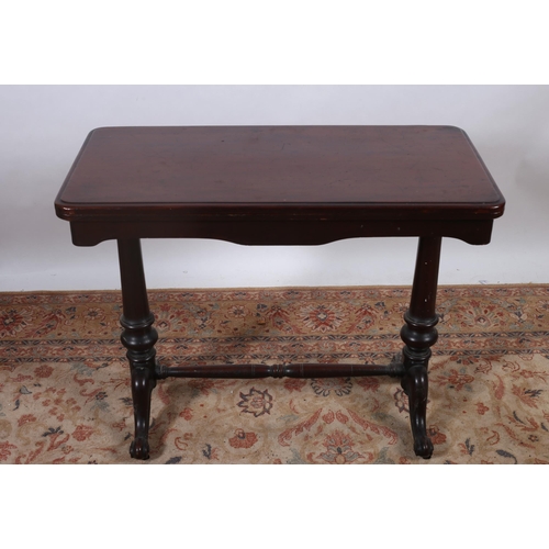 69 - A 19TH CENTURY MAHOGANY FOLDOVER SUPPER TABLE the rectangular hinged top on cylindrical supports wit... 