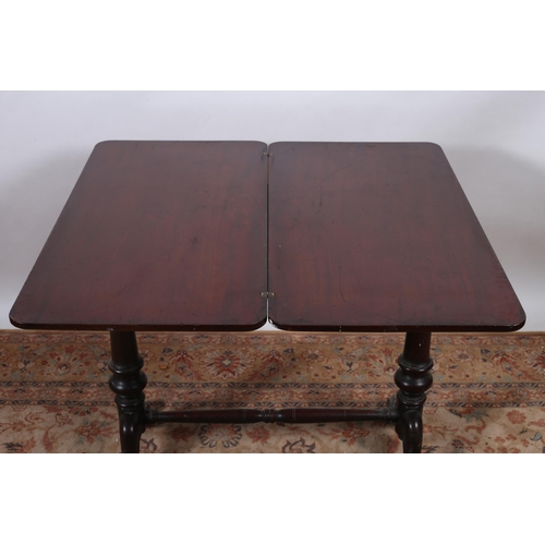 69 - A 19TH CENTURY MAHOGANY FOLDOVER SUPPER TABLE the rectangular hinged top on cylindrical supports wit... 