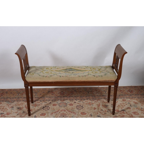 79 - A VINTAGE MAHOGANY AND NEEDLEWORK UPHOLSTERED STOOL of rectangular outline the shaped needlework loo... 