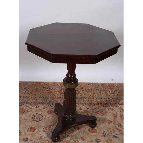 81 - A 19TH CENTURY MAHOGANY AND GILT BRASS MOUNTED TABLE of octagonal outline the shaped top above a lob... 