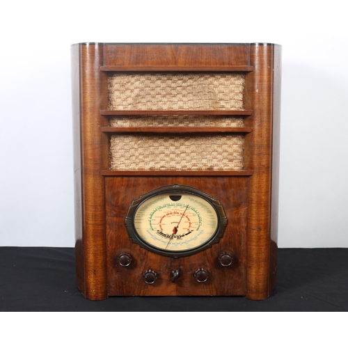 85 - A VINTAGE WALNUT CASE VALVE RADIO 
55cm (h) x 48cm (w) x 30cm (d)