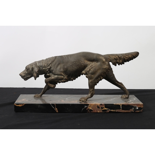 93 - A CAST BRONZE FIGURE modelled as a setter shown standing on veined marble base 
20cm (h) x 42cm (w) ... 