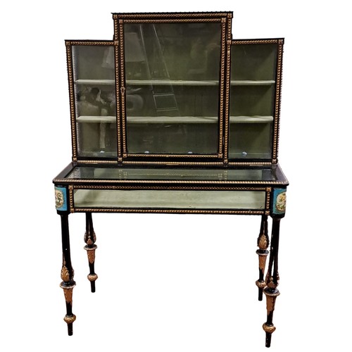 182 - A 19TH CENTURY EBONISED AND PARCEL GILT CURIO CABINET the stepped superstructure with glazed door an... 