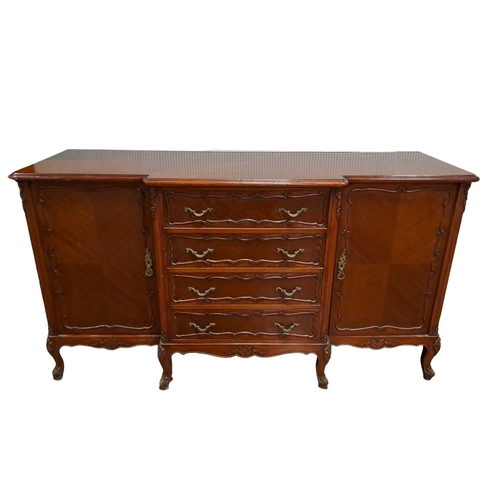 77 - A CONTINENTAL KINGWOOD SIDE CABINET of breakfront outline the shaped top above four long drawers fla... 