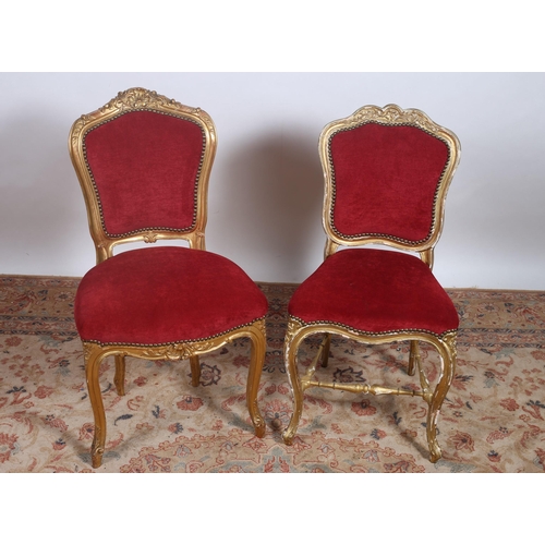 113 - TWO 19TH CENTURY CARVED GILTWOOD SIDE CHAIRS each with a shaped back with upholstered panel and seat... 