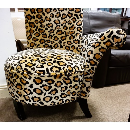 730 - A DESIGNER UPHOLSTERED LEOPARD PRINT HIGH BACK CHAIR on ebonized splayed feet