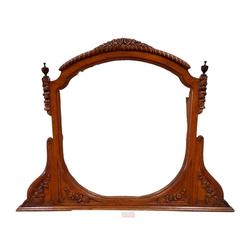 758 - A CONTINENTAL OAK FRAME OVERMANTEL MIRROR the shaped plate within a foliate and flowerhead frame wit... 