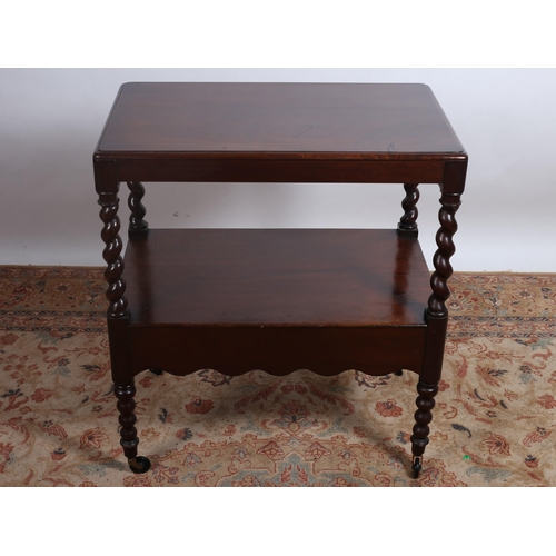 768 - A VINTAGE MAHOGANY TWO TIER TABLE of rectangular outline the shaped top above an open compartment jo... 