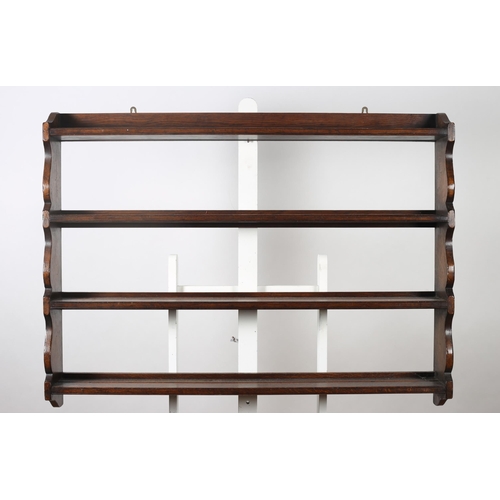 770 - A GEORGIAN STYLE OAK PLATE RACK of rectangular outline the shaped top with moulded gallery above fou... 