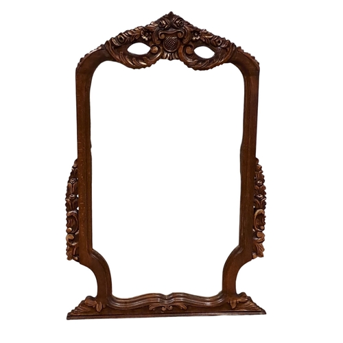 787 - A CARVED OAK FRAME AND PARCEL GILT MIRROR the shaped plate within a pierced foliate and scroll flowe... 