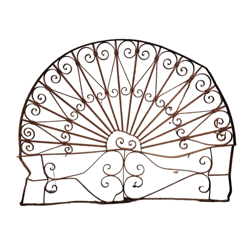 881 - A WROUGHT IRON FAN LIGHT of demi lune outline with scroll decoration 
127cm (h) x 173cm (w)