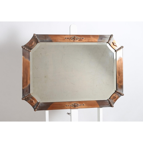 115 - A VINTAGE COPPER FRAME MIRROR the shaped beveled glass plate within a shaped frame
63cm (h) x 89cm (... 