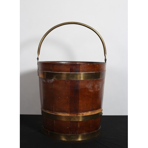 167 - A GEORGIAN STYLE OAK AND BRASS BOUND PEAT BUCKET of circular tapering form with brass swing handle 
... 