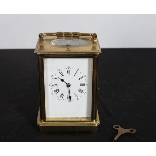 184 - A FRENCH BRASS REPEATER CARRIAGE CLOCK the rectangular case with white enamel dial and Roman numeral... 