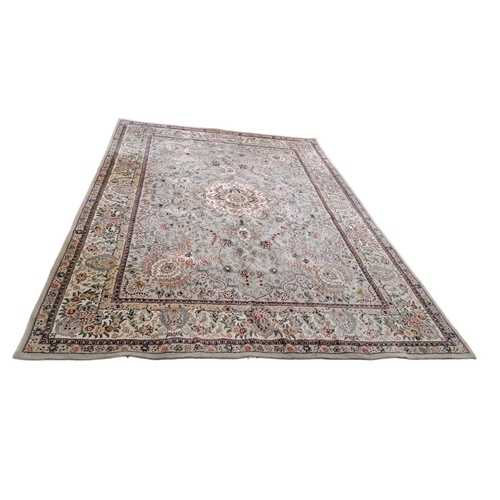 187 - A WOOL RUG the light blue and beige ground with central panel filled with flowerheads and foliage wi... 