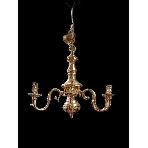 196 - A PAIR OF BRASS SIX BRANCH CHANDELIERS the baluster columns issuing six scroll arms with drip pans 
... 