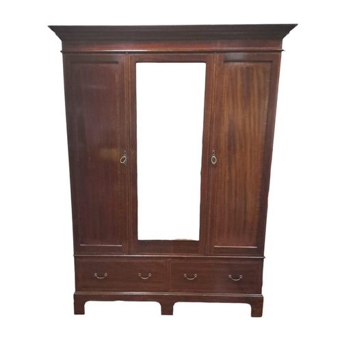 214 - AN EDWARDIAN MAHOGANY AND SATINWOOD INLAID TWO DOOR WARDROBE the outswept moulded cornice above a be... 