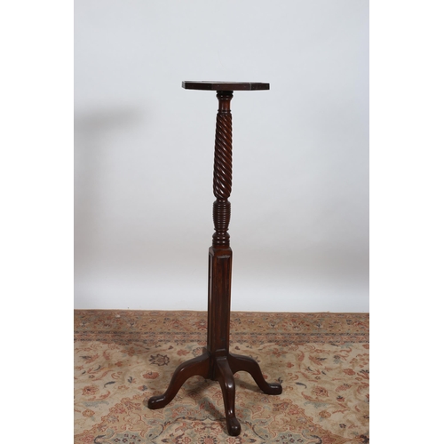 221 - A 19TH CENTURY MAHOGANY TORCHERE the octagonal shaped top above a spiral twist and ring turned colum... 