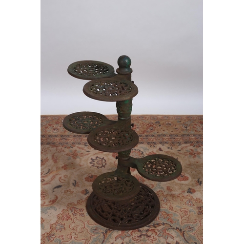 222 - A CAST IRON PLANT STAND the baluster central column issuing six pierced arms raised on a circular pi... 