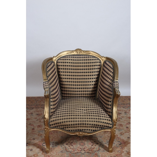 224 - A VINTAGE GILTWOOD AND UPHOLSTERED ARMCHAIR with carved foliate cresting above upholstered panels an... 