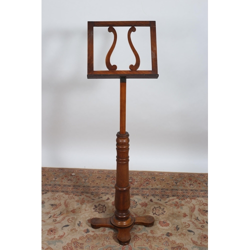 233 - A 19TH CENTURY MAHOGANY MUSIC STAND the lyre shaped sloping rest above a ring turned column on shape... 