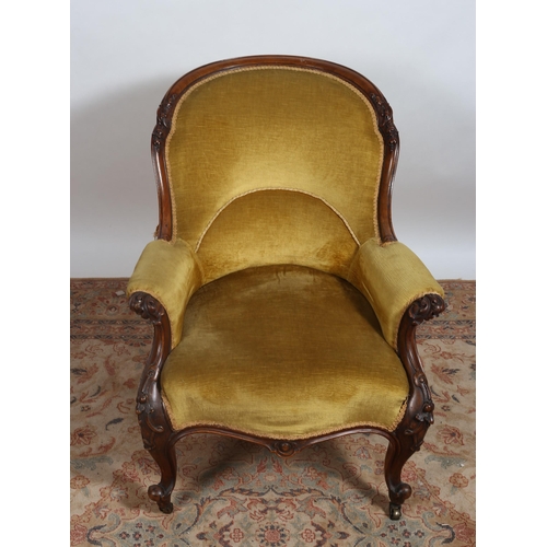 239 - A VICTORIAN CARVED MAHOGANY AND UPHOLSTERED GENT'S CHAIR the curved top rail above an upholstered ba... 