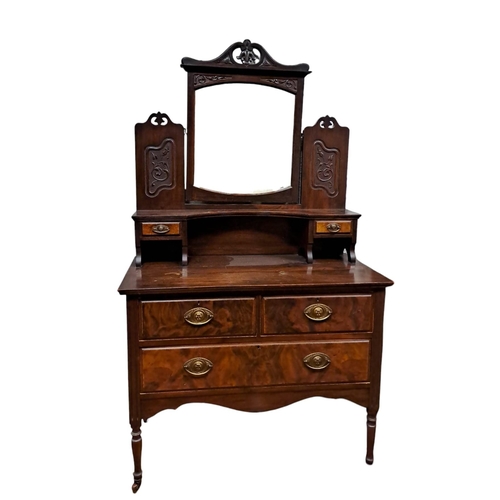 242 - AN EDWARDIAN CARVED MAHOGANY AND WALNUT DRESSING TABLE the superstructure with bevelled glass swivel... 