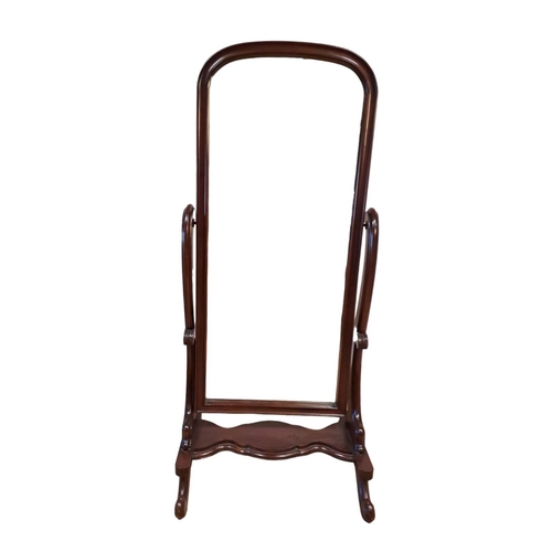 251 - A VICTORIAN STYLE MAHOGANY CHEVAL MIRROR the rectangular arched plate within a moulded frame raised ... 