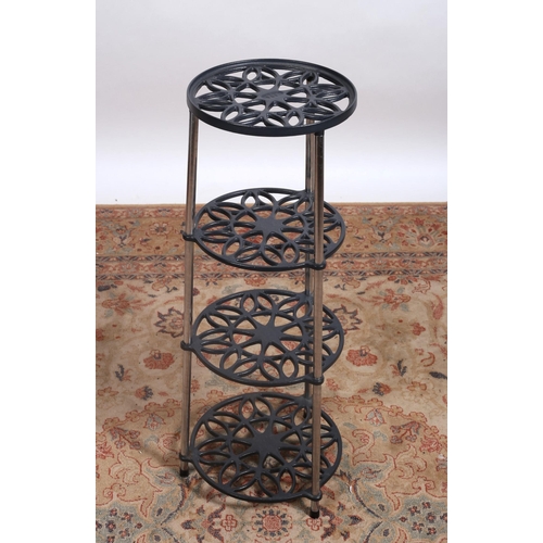 255 - A CAST IRON FOUR TIER STAND of circular form each pierced shelf joined by tubular uprights 
83cm (h)... 