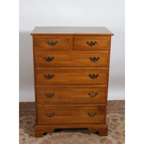 262 - A CHERRYWOOD TALLBOY of rectangular outline the shaped top above two short and four long graduated d... 