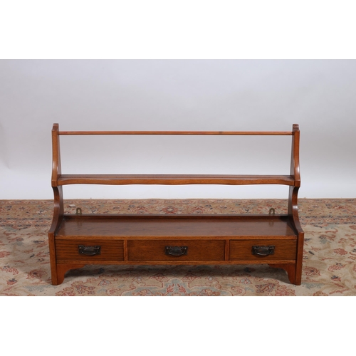 265 - A VINTAGE OAK HANGING PLATE RACK of rectangular form with three frieze drawers and brass drop handle... 