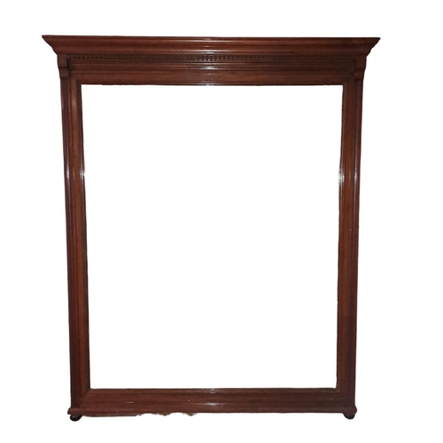 274 - AN EDWARDIAN MAHOGANY MIRROR the rectangular bevelled glass plate within a moulded frame with carved... 