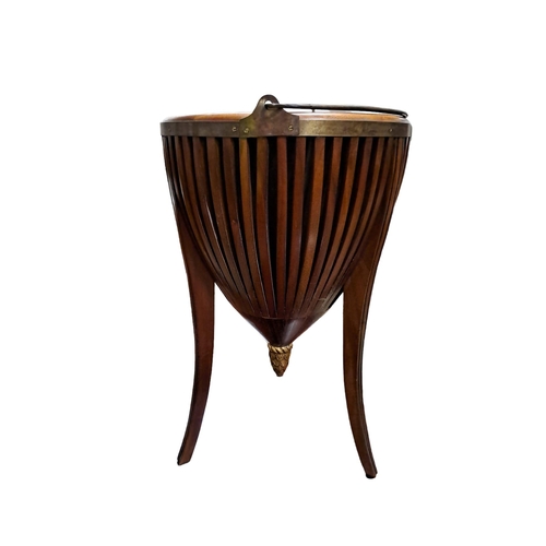 282 - A MAHOGANY BRASS BOUND AND GILT JARDINIERE STAND of circular tapering form the pierced slatted friez... 