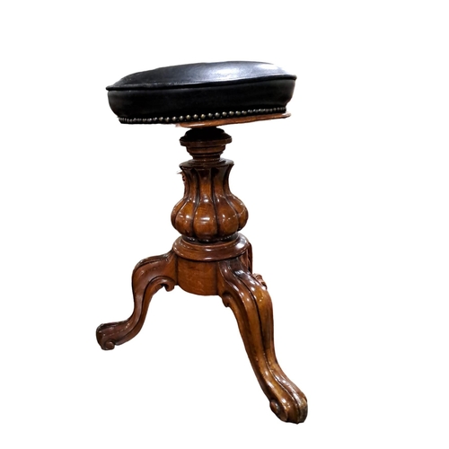 283 - A 19TH CENTURY MAHOGANY REVOLVING STOOL the circular hide upholstered seat above a lobed column on t... 