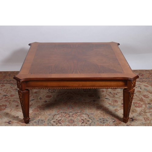 290 - A MAHOGANY CROSSBANDED COFFEE TABLE of rectangular outline the shaped top with eared corners on tape... 