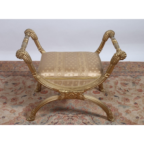 303 - A CONTINENTAL GILT FRAME AND UPHOLSTERED STOOL with carved scroll uprights joined by a baluster stre... 