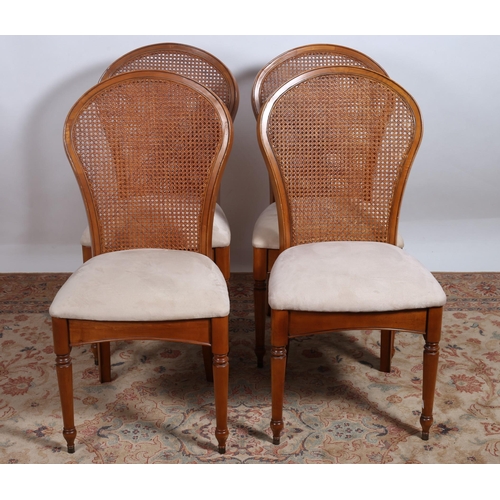 305 - A SET OF FOUR BEECHWOOD AND UPHOLSTERED DINING CHAIRS each with a curved caned panel and back with u... 